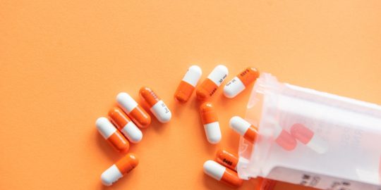 orange and white medication pill
